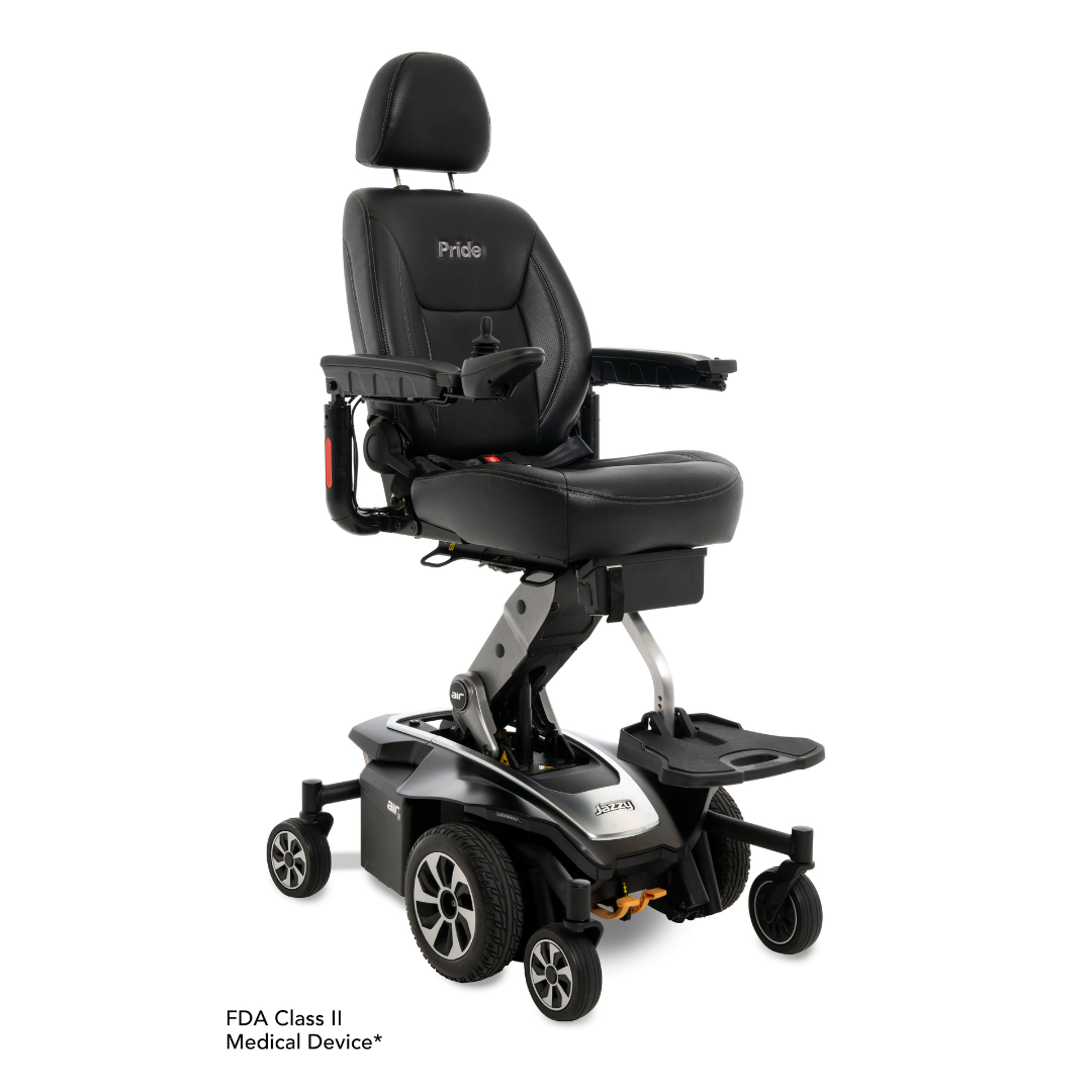 A black Pride Mobility Jazzy Air® 2 Powerchair with seat elevation, high back, armrests, footrest, headrest, and sturdy wheels featuring Mid-Wheel 6® Technology. “Pride” is on the backrest. Below: “FDA Class II Medical Device.”.